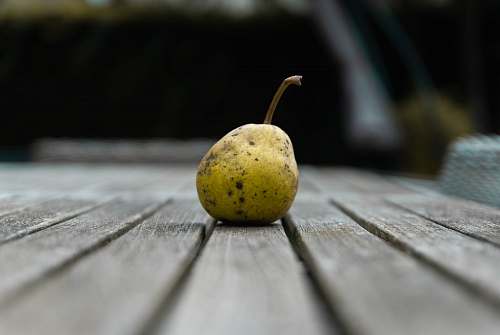 plant yellow fruit on brown wooden table fruit