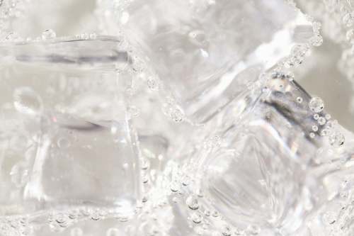 grey clear glass container on white textile ice