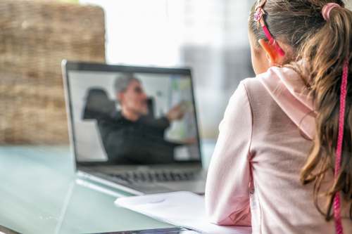 schoolwork woman in pink long sleeve shirt sitting in front of macbook pro schooling
