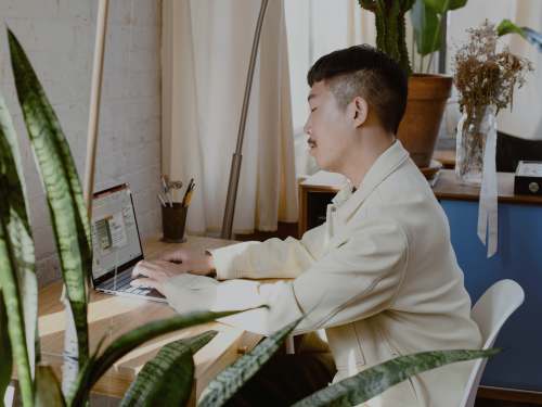 human man in white dress shirt sitting on chair person