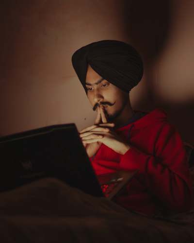 laptop woman in red jacket sitting on chair black