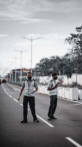 hulhumale man in white shirt and black pants standing on road during daytime malé