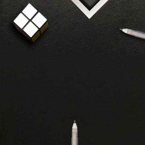 white white and black cube on black surface flatlay