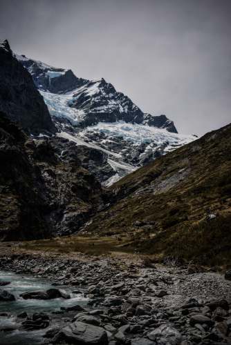  landscape photography of snowy mountain under cloudy sky 