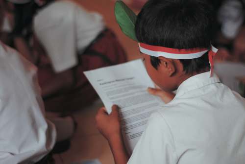 education boy reading a paper kids