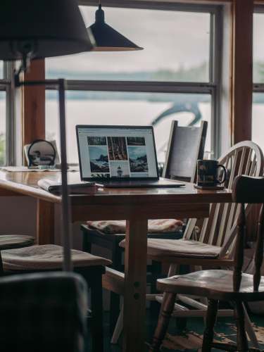  black laptop computer on brown wooden table 
