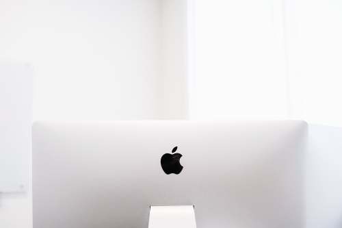  silver macbook on brown wooden table 