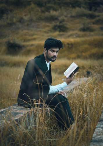 clothing man in black suit holding book face
