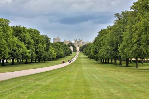 england green grass field with trees and white building in distance castle hill