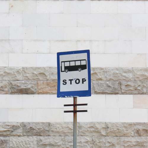  blue and white signage on white concrete wall 