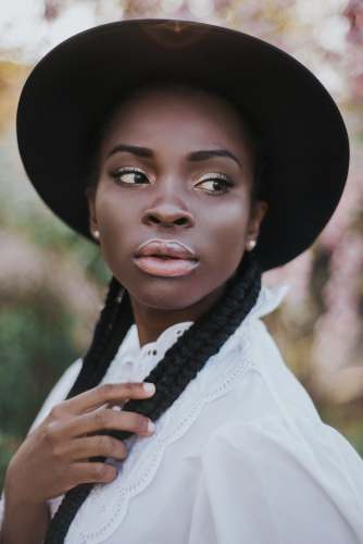 portrait woman in white dress shirt wearing black hat style