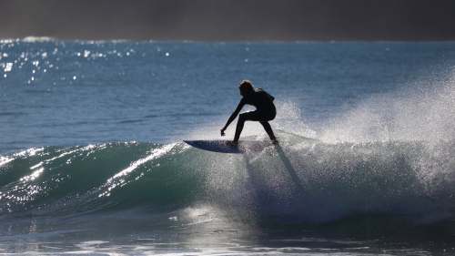  person riding surfboard on water barrel 