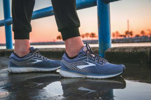  person wearing blue and white running shoes 