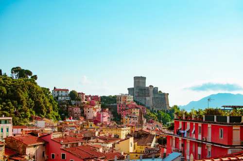 lerici red and white concrete buildings under blue sky 